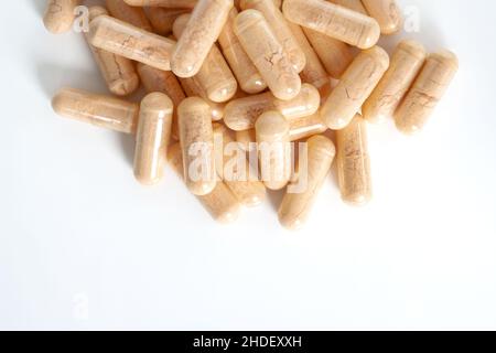 Detail of orange multivitamin supplements isolated on white background. Stock Photo