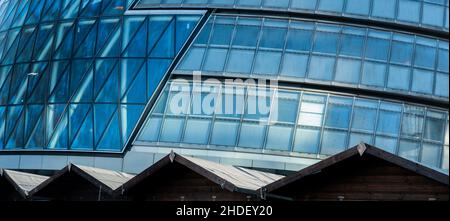 A zigzag of huts cuts through the glass and steel of County Hall, seat of local government in London, UK Stock Photo