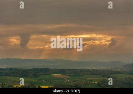 Close-up view of the sun rays bursting through the clouds from the observation deck on Mount Uetliberg in Zurich, Switzerland. Dramatic natural lighti Stock Photo