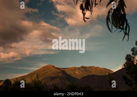 The light of the sunset and the shadows of the clouds over the Iguaque mountain in the eastern Andes range of central Colombia. Stock Photo