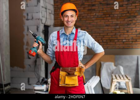 Young construction workers in hard hats in a buiding Stock Photo