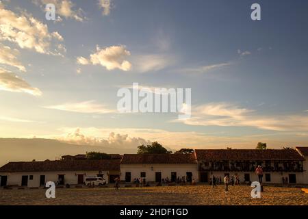 Villa de Leyva, Boyaca, Colombia - February 19, 2018: People enjoy a beautiful afternoon in the main square of the colonial town. Stock Photo