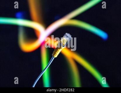 Internet cable and yellow ethernet connector in close up against a colourful background. Stock Photo