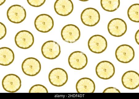 Pattern made of backlit lemon slices on white background Stock Photo