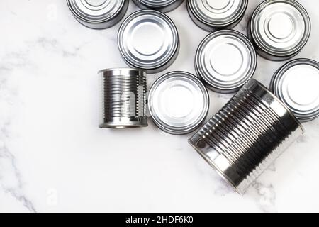Cans of preserves on a marble background in a top view Stock Photo