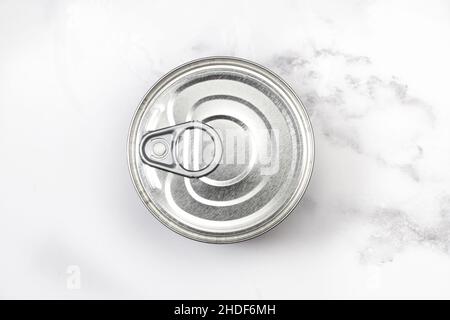 Closed can of preserves on a marble background in a top view Stock Photo