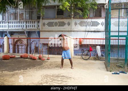 Unidentified Indian wrestlers do exercise by lifting their traditional equipments near ganga Ghat in Varanasi, Uttar Pradesh, India. Stock Photo