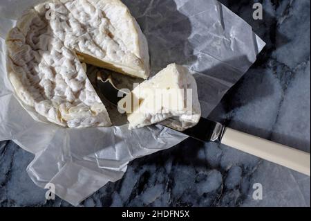 french camembert cheese on marble table top Stock Photo