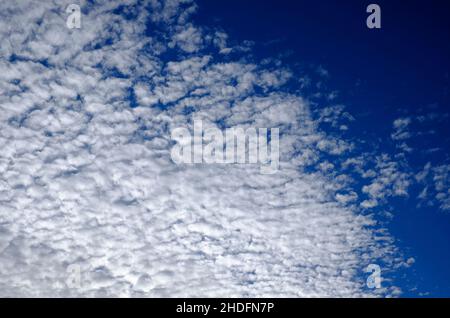 white fluffy clouds on blue sky background Stock Photo