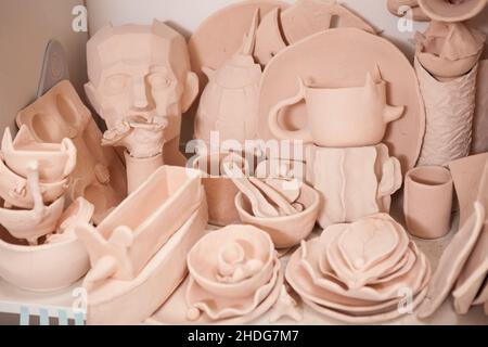 Various pottery and clay kitchenware on the shelf at pottery class Stock Photo