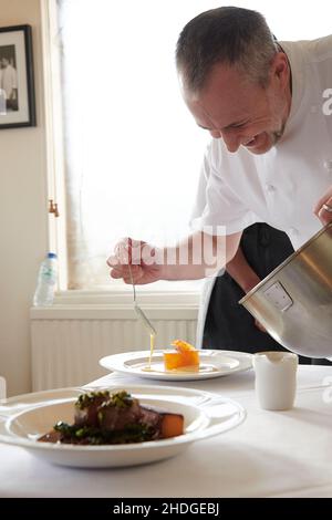 Michel Roux Jr, covering Blood Orange and whisky jelly with Crème anglaise Stock Photo