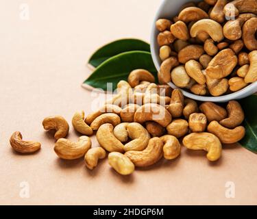Tasty cashew nuts in bowl on a old wooden table Stock Photo - Alamy