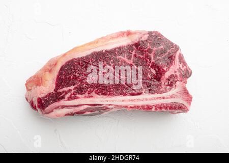 Fresh, huge and appetizing dry aged club steak set, on white stone background Stock Photo