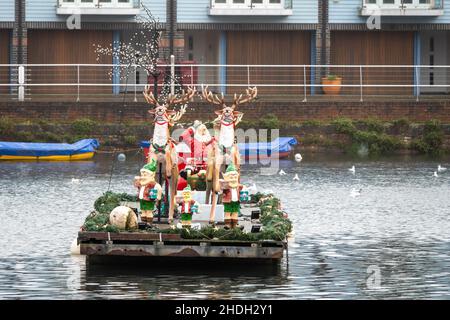 Father Christmas on his sleigh on Chichester Canal West Sussex England Stock Photo