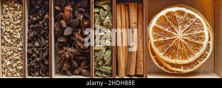 set of spices for mulled wine in a wooden box close-up Stock Photo