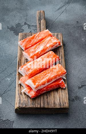 Crab sticks seafood semi finished fish mince with blue swimming crab set, on wooden cutting board, on gray background Stock Photo