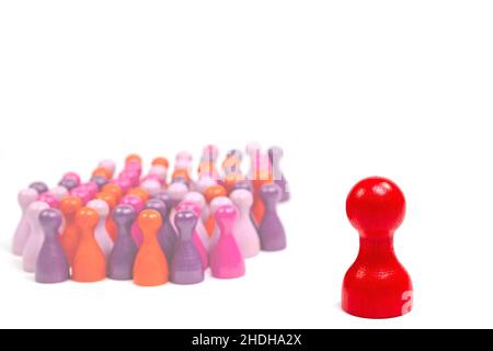 Lots of colorful small wooden cones and a large red wooden cone against a white background Stock Photo