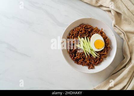 Korean Instant Noodle with Black Bean Sauce topped cucumber and boiled egg (Jajangmyeon or JJajangmyeon) - Korean food style Stock Photo