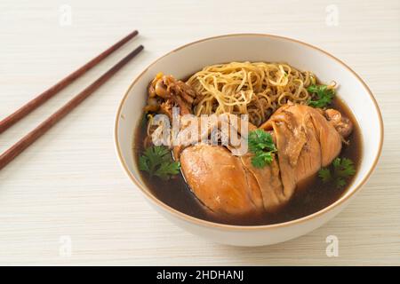 Noodles with Braised Chicken in Brown Soup Bowl - Asian food style Stock Photo