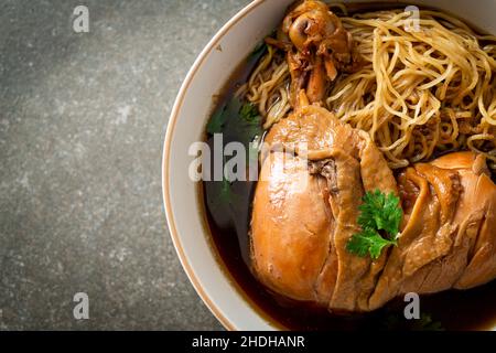 Noodles with Braised Chicken in Brown Soup Bowl - Asian food style Stock Photo