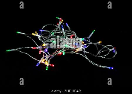 String of LED Christmas tree lights isolated on a black surface Stock Photo