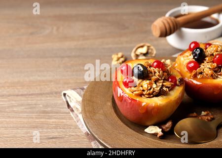 Concept of tasty food with baked apples on wooden background Stock Photo