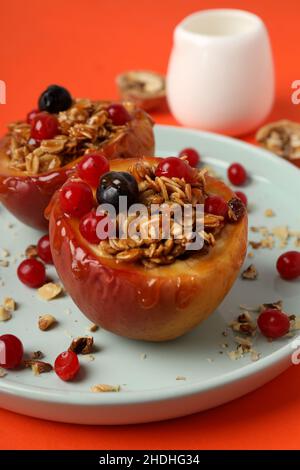 Concept of tasty food with baked apples on orange background Stock Photo