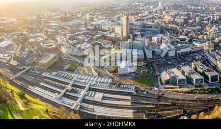 SHEFFIELD, UK - DECEMBER 16, 2021. Aerial view of Sheffield city centre cityscape with Sheffield railway and tram station from above Stock Photo