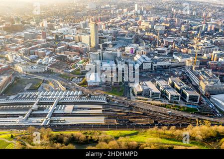SHEFFIELD, UK - DECEMBER 16, 2021. Aerial view of Sheffield city centre cityscape with Sheffield railway and tram station from above Stock Photo