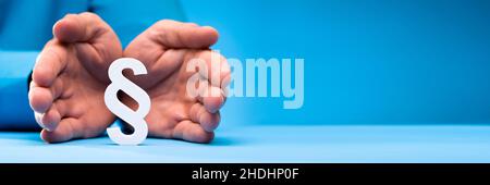 Businessperson's Hand Holding Paragraph Symbol. Legal Court Stock Photo