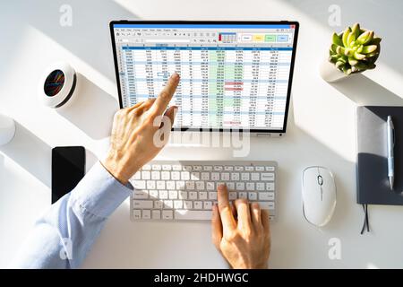 Electronic Spreadsheet Analyst Or Auditor Using Software On Hybrid Laptop Stock Photo
