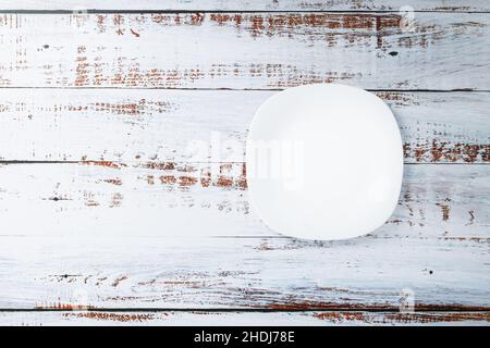 White ceramic bowl on a white background top view. Minimalistic concept Stock Photo
