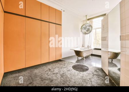 Comfortable large bathroom with a clawfoot bathtub and gray floor Stock Photo