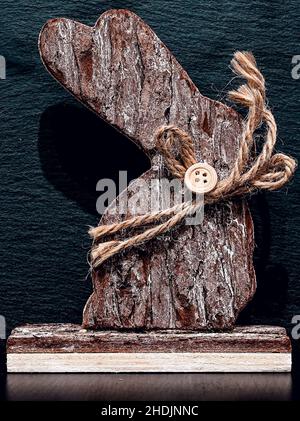 A rabbit carved from wood on black background Stock Photo