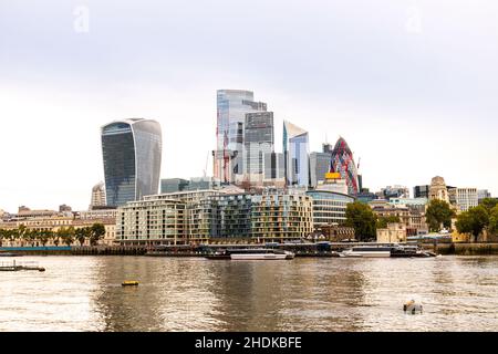 A view across the River Thames, London, surrounded by skyscrapers and other buildings of many designs to fill the skyline. Stock Photo