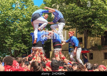 GIRONA, SPAIN - MAY 14, 2017: This is the construction of a tower of people, called castel, during the city tht Flower Festival. Stock Photo