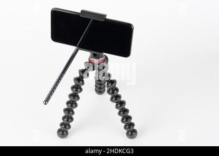Touch screen smartphone on mount and flexible tripod. Stock Photo