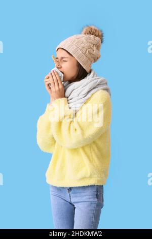 Ill young woman with clothespin on her nose against color background Stock Photo