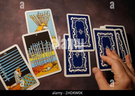 Varna, Bulgaria - November, 02, 2021: solitaire layout, female hands spread tarot cards on the table Stock Photo