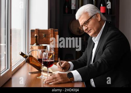 Mature sommelier tasting types of wine Stock Photo