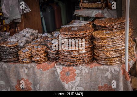 Bandi peanuts or Peanut Brittle sold at San Joaquin, Iloilo. A delicious snack of caramelized sugar and nuts with sesame seeds, shown here sold at a s Stock Photo