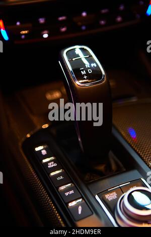 Automatic gear stick of a modern car, multimedia and navigation control buttons. Car interior details. Transmission shift. Shallow dof Stock Photo