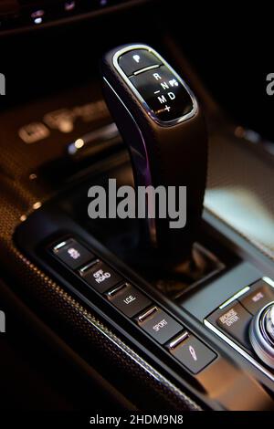 Automatic gear stick of a modern car, multimedia and navigation control buttons. Car interior details. Transmission shift. Shallow dof Stock Photo