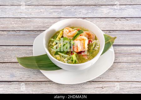 Green curry is a very spicy curry variety used in Thai cuisine. The composition of curry is very diverse and depends on the area where it is made, coc Stock Photo