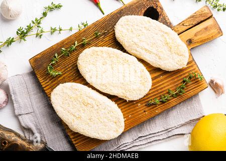 Fish cutlets from minced cod set, on white stone table background, top view flat lay Stock Photo