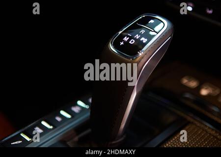 Automatic gear stick of a modern car, multimedia and navigation control buttons. Car interior details. Transmission shift. Shallow dof Stock Photo