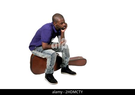 Handsome young black man with a acoustic guitar case Stock Photo