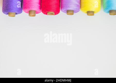 Colorful thread spools on a white background with copy space for text Stock Photo