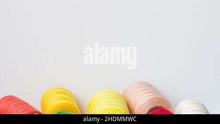 Sewing thread rolls, spools on a white background with copy space for text Stock Photo