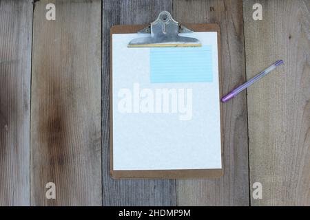 Clipboard With Blank Sheet of Paper on Wooden Table Flat Background Image Stock Photo